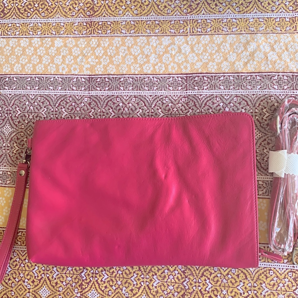 Pink clutch with shoulder strap and wrist strap